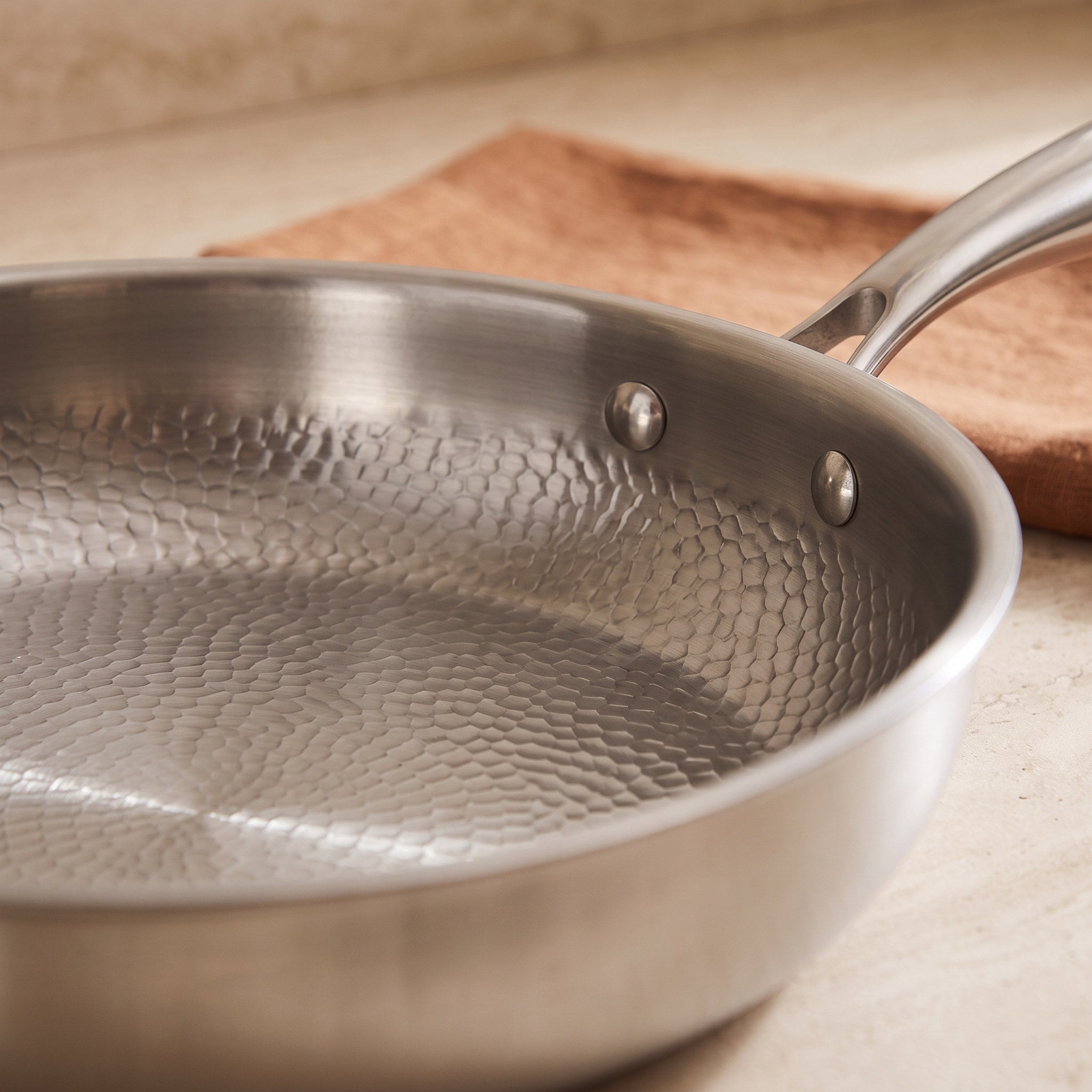 Hammered interior and polished riveted handle