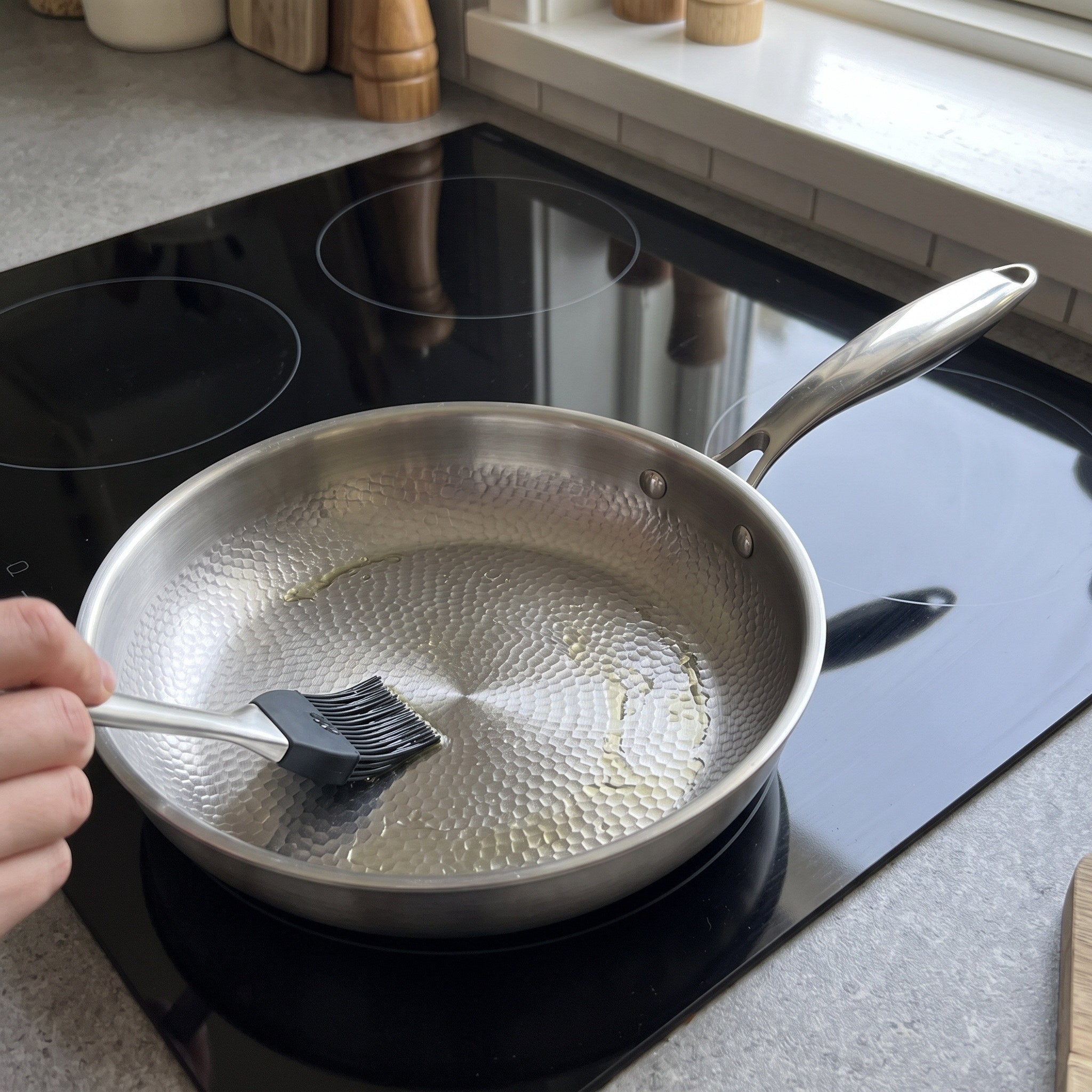 Oil being spread over the hammered surface