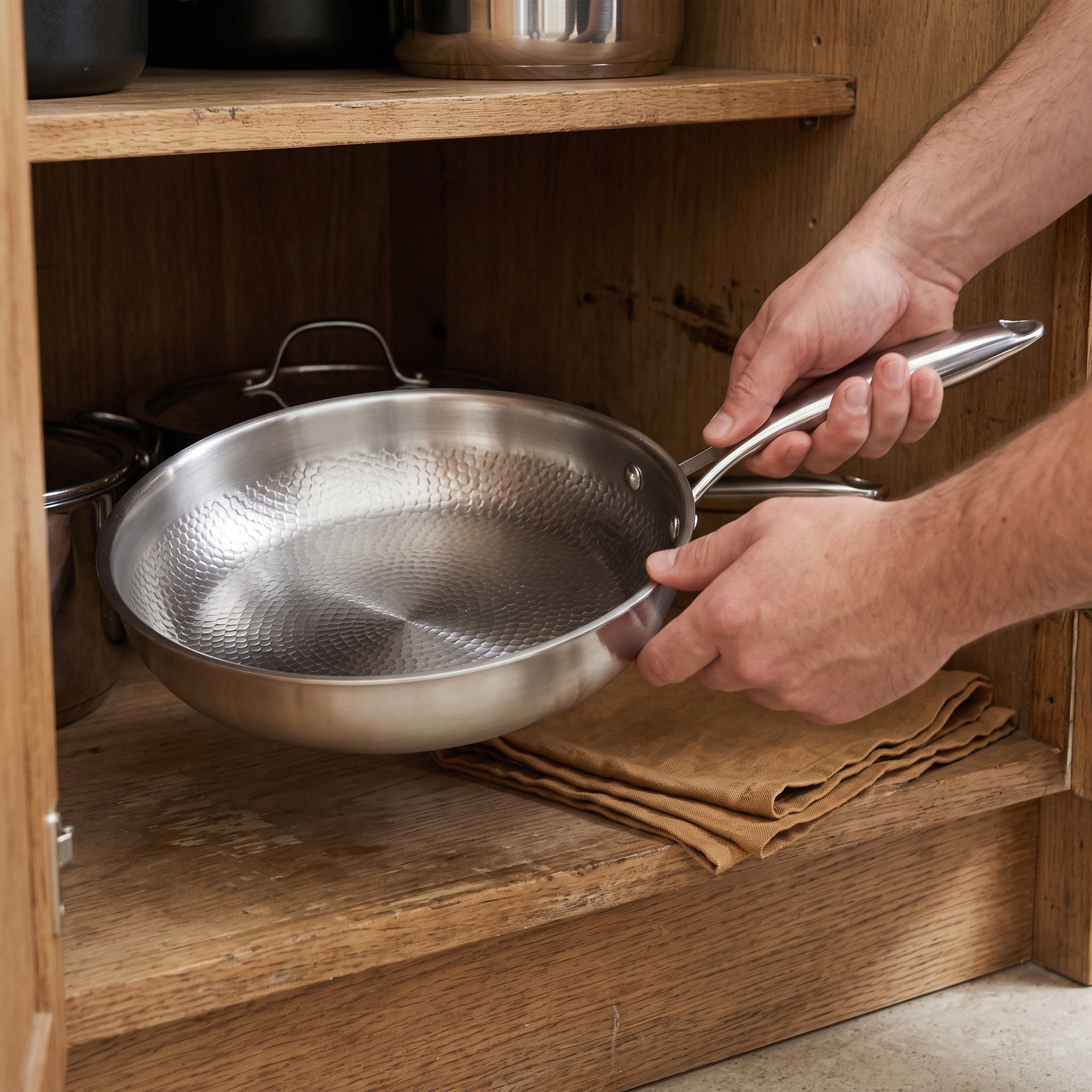 Dry pan being put in a cupboard